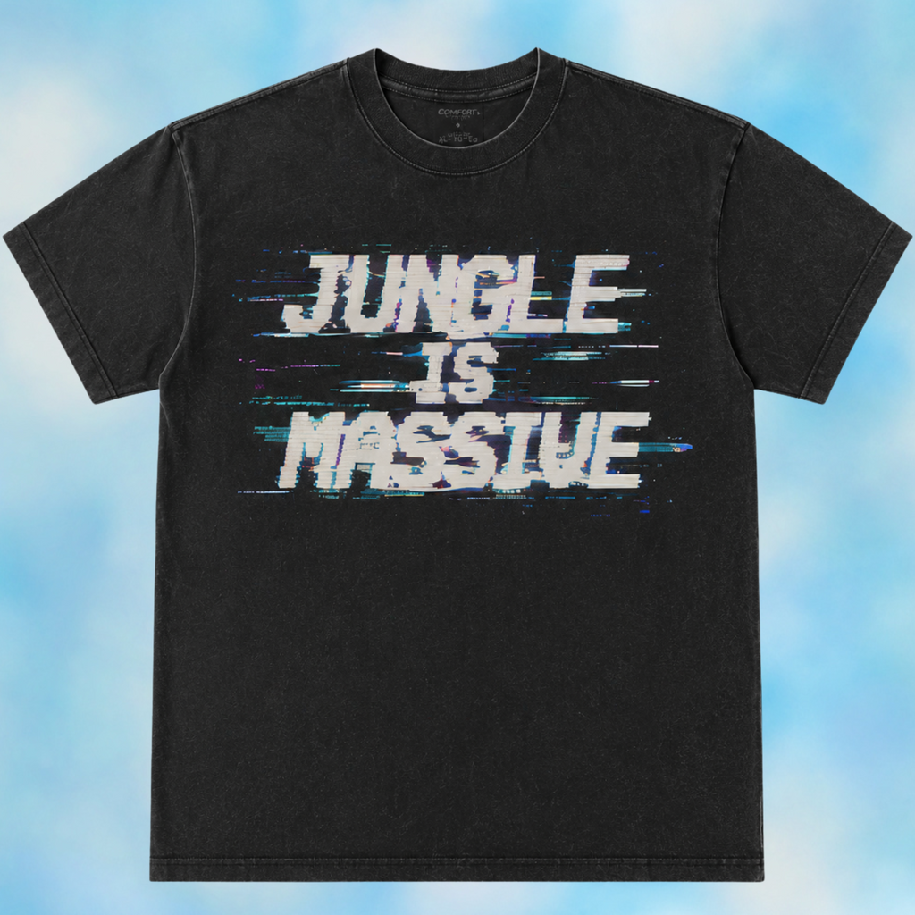 A black short-sleeve t-shirt with a distressed white graphic reading 'JUNGLE IS MASSIVE' with blue glitch-style horizontal lines, displayed against a light blue cloudy background.