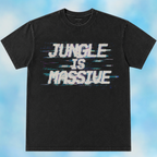 A black short-sleeve t-shirt with a distressed white graphic reading 'JUNGLE IS MASSIVE' with blue glitch-style horizontal lines, displayed against a light blue cloudy background.