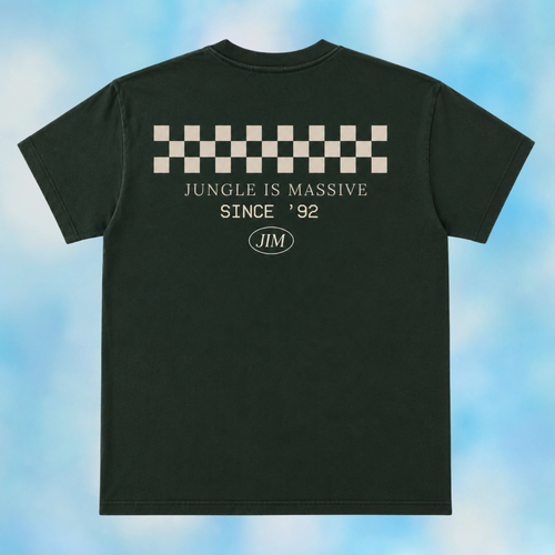 A dark forest green t-shirt shown from the back, featuring a beige and white checkerboard graphic above the text 'JUNGLE IS MASSIVE SINCE '92' and an oval 'JIM' logo, set against a light blue cloudy background.